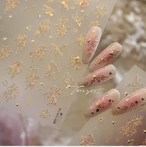 Close-up of metallic rainbow fireworks and butterfly nail stickers on pink gradient nails