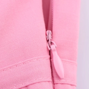 Close-up of high-quality invisible pink zipper on textured fabric for tube top