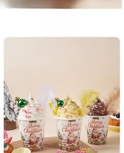 Macro detail of Christmas themed paper cups with festive ice cream and holiday decor