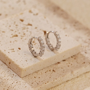 Close-up of silver S925 sterling silver hoop earrings with a row of sparkling cubic zirconia