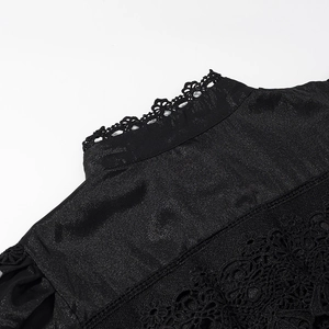 Detail of elegant black dress showing lace stand collar and intricate floral embroidery