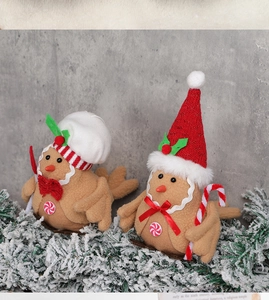 Close-up of Christmas gingerbread bird figurines with felt hats and knit scarves