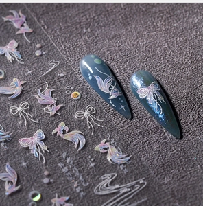 Detail showing laser iridescent butterfly and fish nail stickers on dark blue base