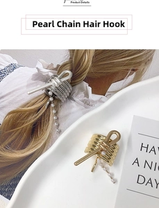 Close-up of elegant pearl chain hair hook with gold and silver bow metal detail