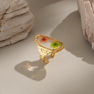 Gold-plated stainless steel open ring with orange and green dried flowers in clear resin