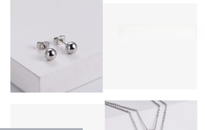 Vue macro des boucles d'oreilles boules polies et chaîne assortie de la parure