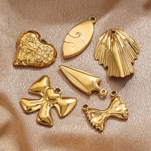Set of 6 golden titanium steel pendants with geometric and bow shapes on silk