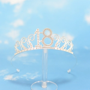 Detailed view of silver 18th birthday crown with sparkling crystals and display base