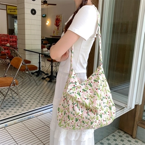 Model showing a large capacity white canvas tote bag with pink tulip floral patterns