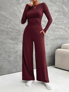 Deep red long sleeve crew neck jumpsuit with elegant wide-leg trousers for a sleek look