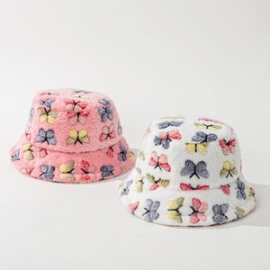 Plush faux fur bucket hats with colorful butterfly patterns in pink and white
