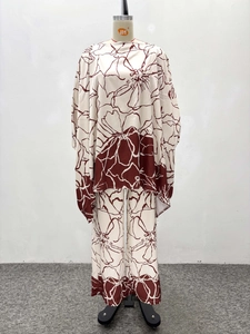 Detail of floral print on long sleeve top and wide leg pants set in beige and brown