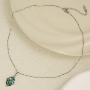 Close-up of oval 304 stainless steel pendant featuring iridescent abalone shell inlay