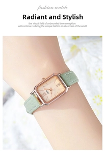 Close-up of elegant gold rectangular quartz watch with a textured green leather strap