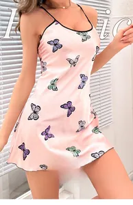 Detail of pink silk satin slip dress featuring elegant purple butterfly prints and black trim
