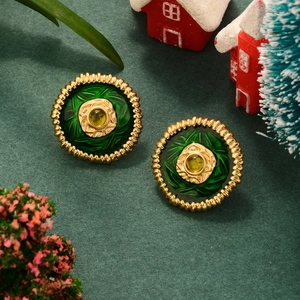 Detailed macro view of vintage gold flower earrings with green enamel and yellow stone