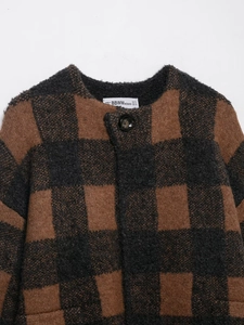 Detail showing the thick plush texture and black round button on vintage plaid cardigan