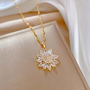 Elegant gold sunflower necklace with sparkling crystals on a premium silk background