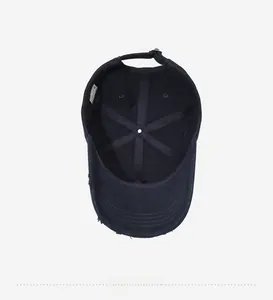 Detailed interior of a distressed navy cotton baseball cap with labels and metal buckle