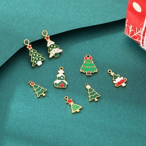 Detailed view of colorful enamel Christmas tree pendants and small house charms