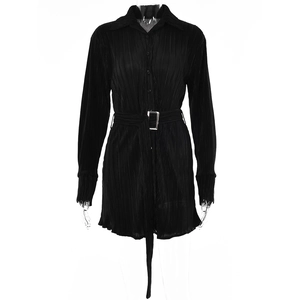 Detail of black long-sleeved pleated dress with metal buckle belt and ruffled cuffs