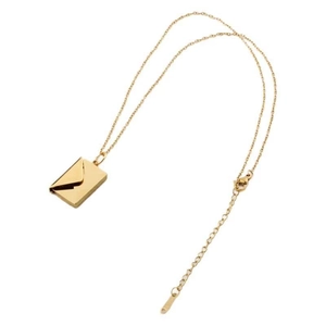 Detail of a golden envelope pendant necklace showing the fine chain and metallic texture