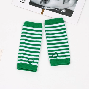 Detail of green and white striped knit arm warmers with thumb holes on white background