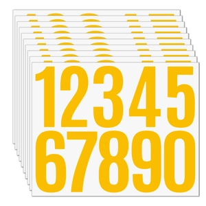 Macro view of stacked yellow 3-inch vinyl number stickers for mailboxes and labeling