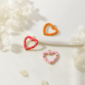 Macro view of macaron enamel heart pendants with colorful inlaid zircon stones