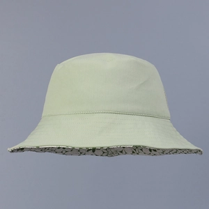 Gros plan d'un chapeau bob en velours côtelé vert clair avec doublure florale