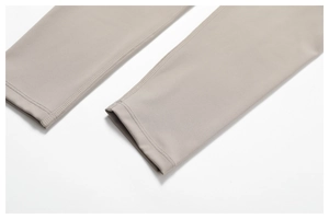 Close-up of double-needle stitching on high-stretch khaki yoga leggings' ankle cuffs
