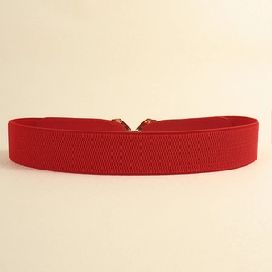 Detailed close-up of red elastic wide waist belt with woven texture and metal buckle clasp