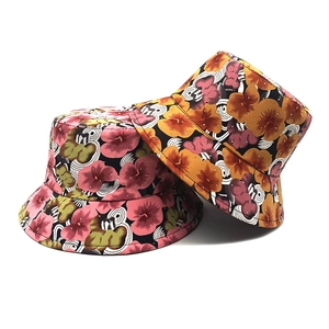 Digital floral print bucket hat with abstract sun patterns for outdoor sun protection