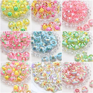 Colorful DIY fruit beads with strawberry and banana patterns in a clear tray