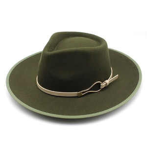 Detail of dark green wool fedora with light beige leather band and gold horseshoe buckle