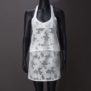 Detailed view of the white lace two-piece set featuring leaf patterns and halter neck design