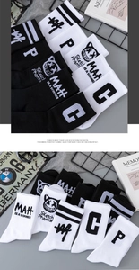 Detail of knit crew socks featuring cartoon cat prints and street style typography
