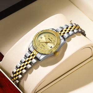 Close-up of gold two-tone quartz watch for women with rhinestones and date display