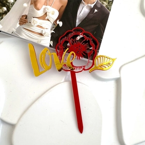 Dettaglio del topper per torta in acrilico con rosa rossa e scritte LOVE dorate per decoro