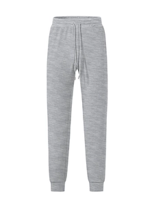 Detail of grey waffle knit jogger pants featuring drawstring waistband and textured fabric