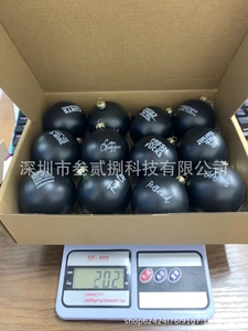 Funny black Christmas ornaments set of 12 showing product weight on a digital scale