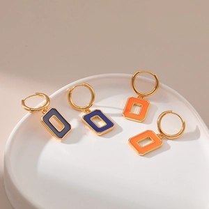 Detail of 18K gold plated hollow square earrings with blue and orange enamel drip