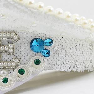 Luxury white sequin military hat with feather, pearls, and rhinestone letter E detail