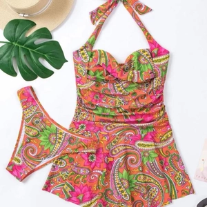 Two-piece halter swim dress with bright orange paisley floral print and matching bottom