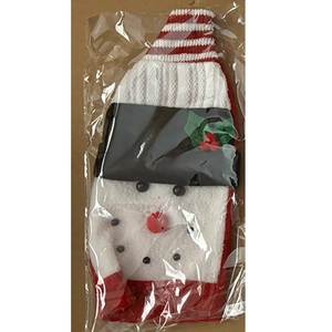 Detail of knitted snowman wine bottle cover with red striped hat and soft plush material