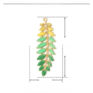 Detail view of a green enamel leaf pendant in stainless steel with exact measurements