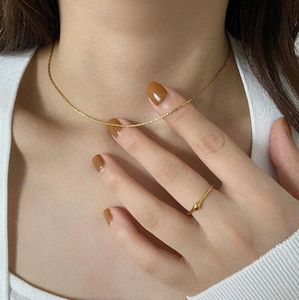 Minimalist gold ultra-thin necklace and teardrop ring set for layered everyday jewelry style