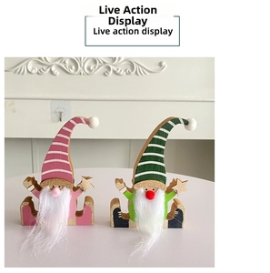Close-up of wooden Christmas gnomes with striped hats and white beards for festive decor