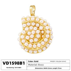 Detailed view of pearl-encrusted conch shell pendant in gold finish, 37mm x 25mm size