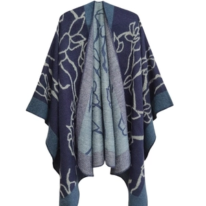 Women's jacquard knit shawl cape with navy blue floral patterns and tassel edges
